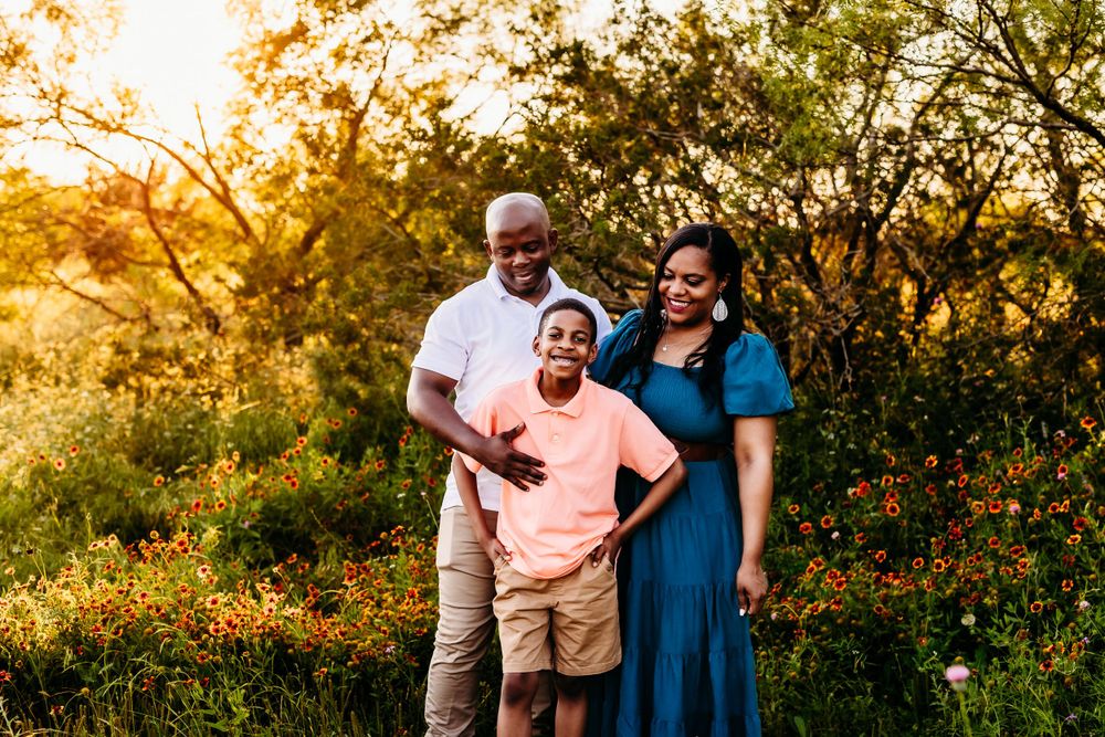 Family enjoying a sunset photo session in a natural outdoor setting.