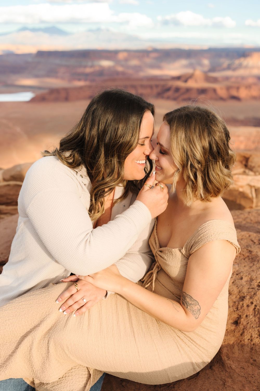 Romantic couple sharing intimate moment at scenic desert overlook.