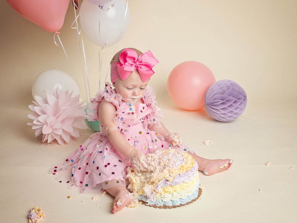 baby smashing cake for first birthday
