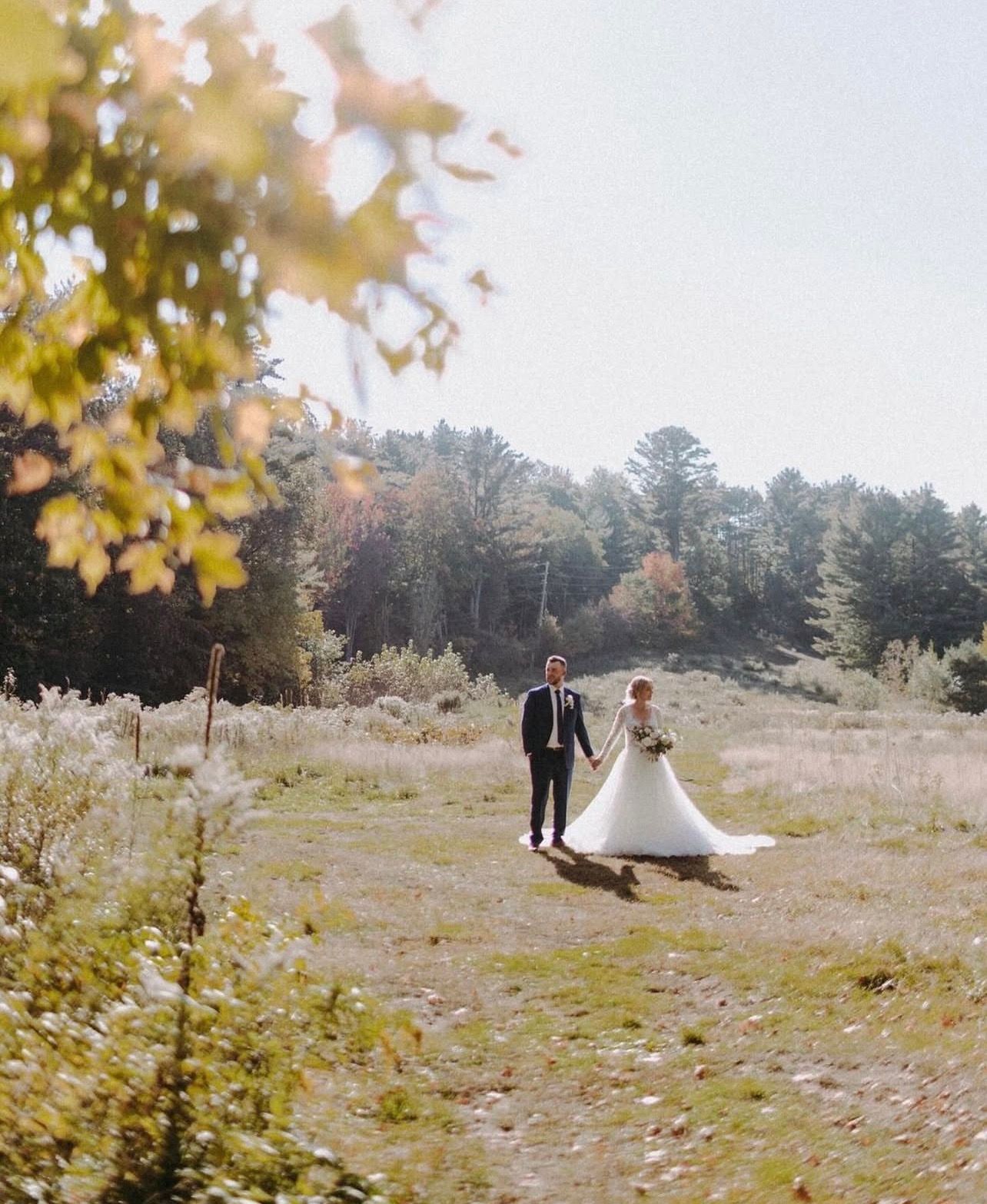 Wedding couple shares intimate dance moments on wooden floor with natural light streaming in.