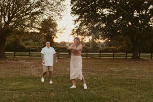 Candid family moments captured in rustic field at golden hour.