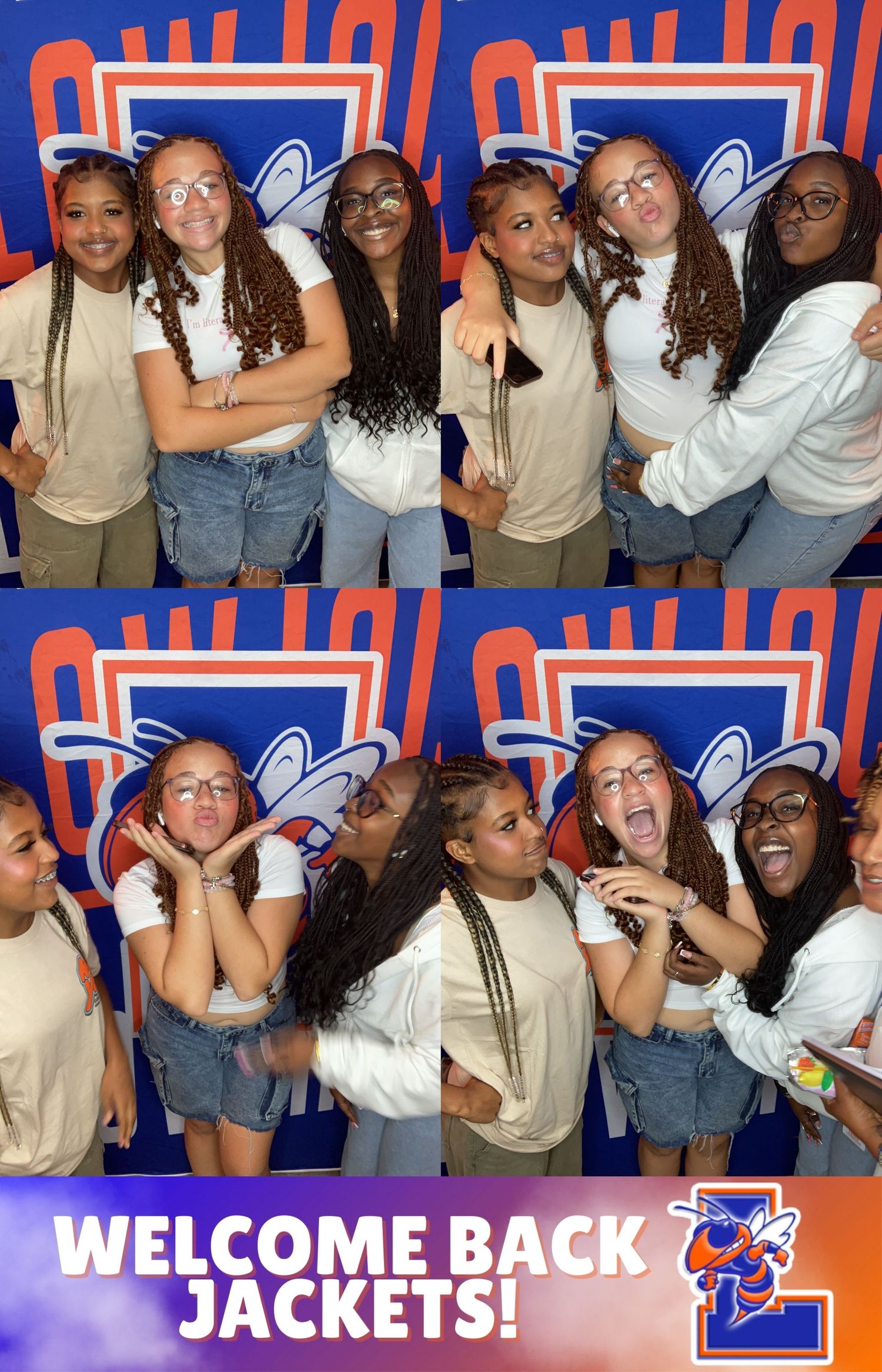 Students pose together at a welcome back event with a blue and orange striped background.