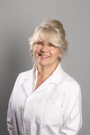 A series of five professional headshots showing someone in a white collared shirt against a gray background.