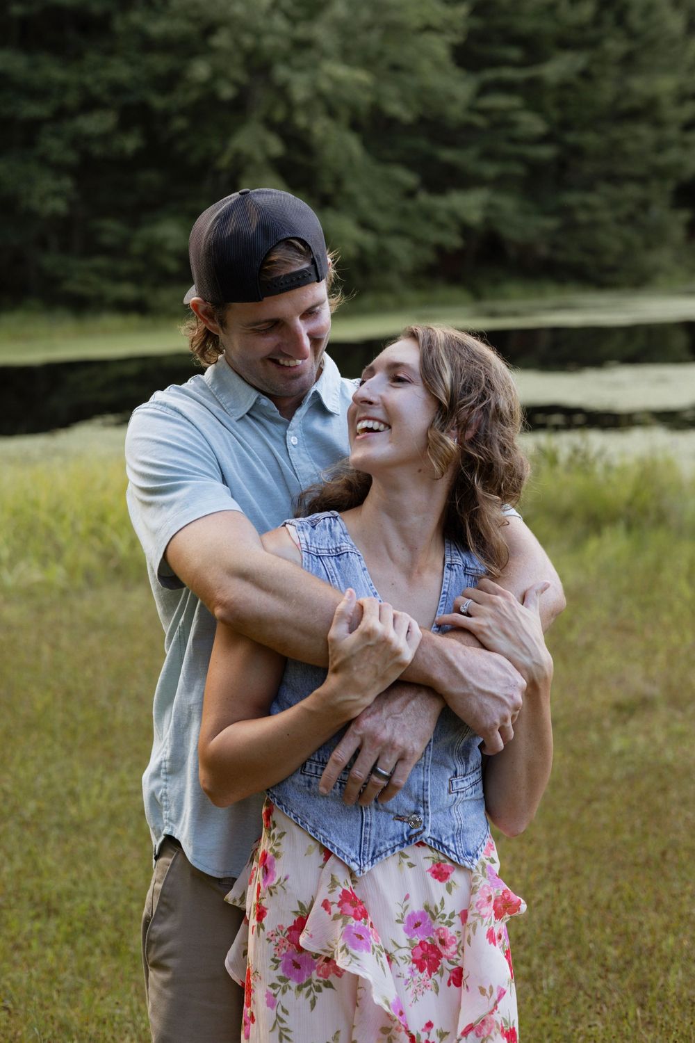 Couple hugging near a pond