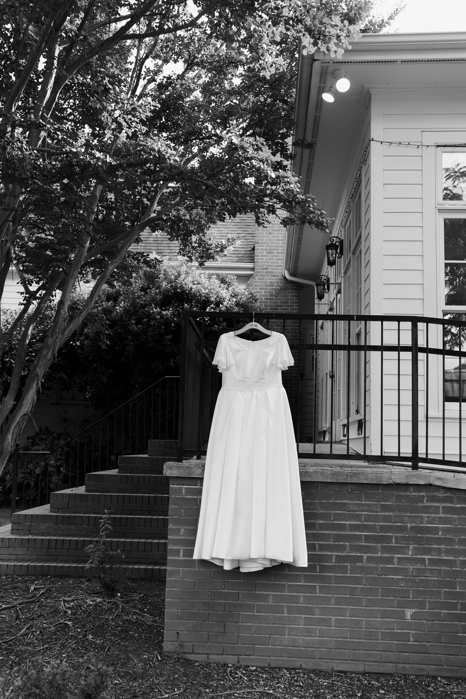Bride's wedding dress hung and displayedRand Bryan House Photos by Beth MK Photo