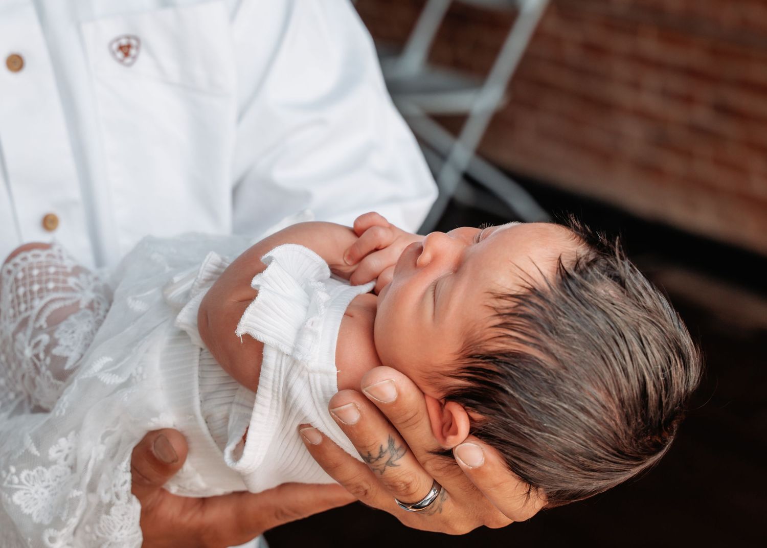 Father holding his newborn daughter during a natural newborn photography session