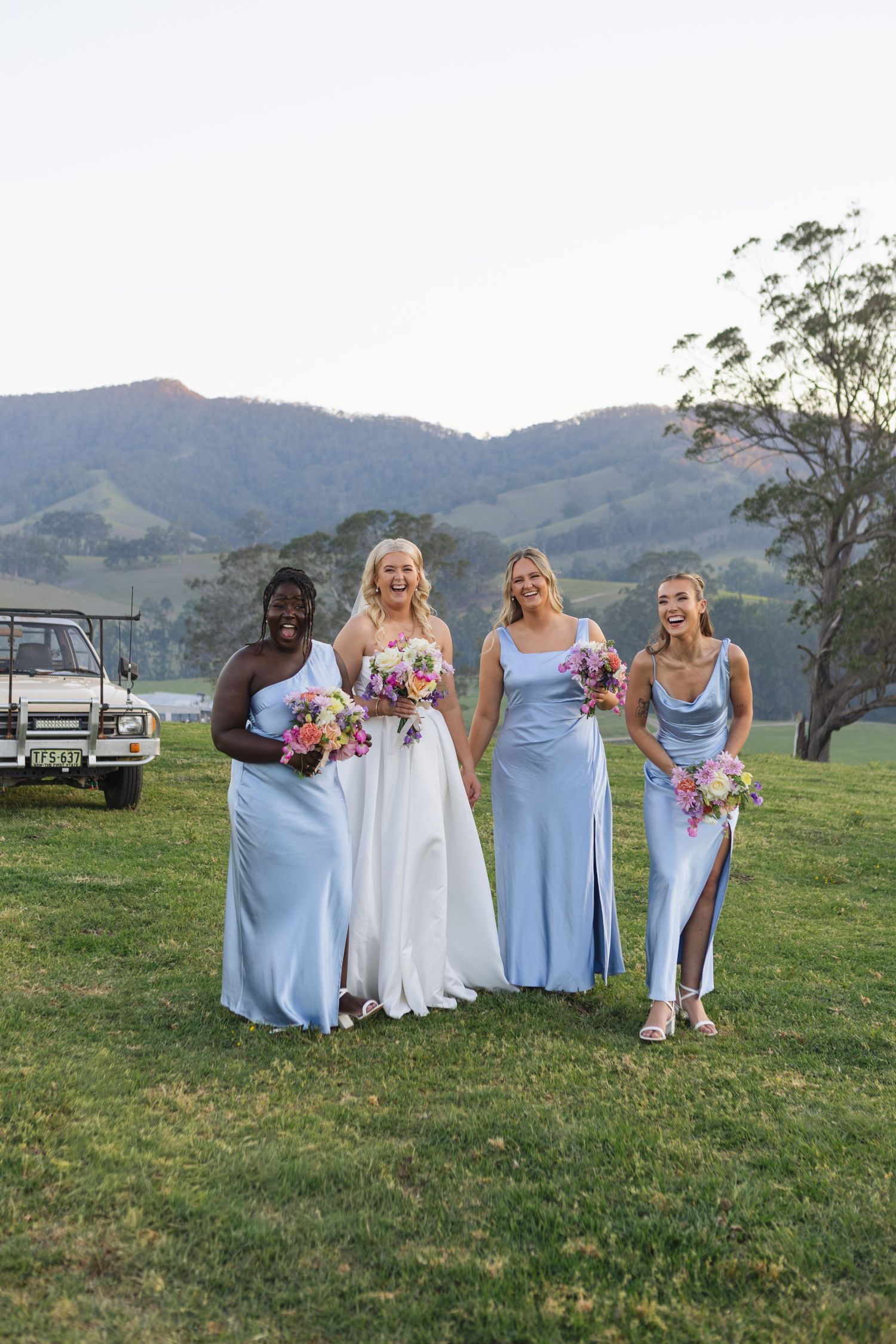 Bride and bridesmaids laughing during sunset wedding portraits at Dungog Weddings in the Hunter Valley NSW