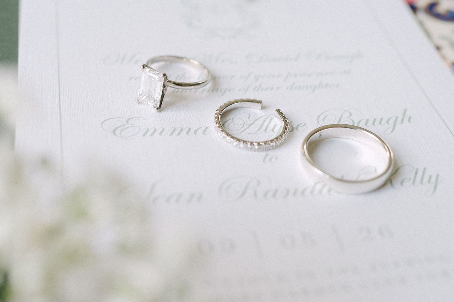 Close up of engagement ring and wedding bands.