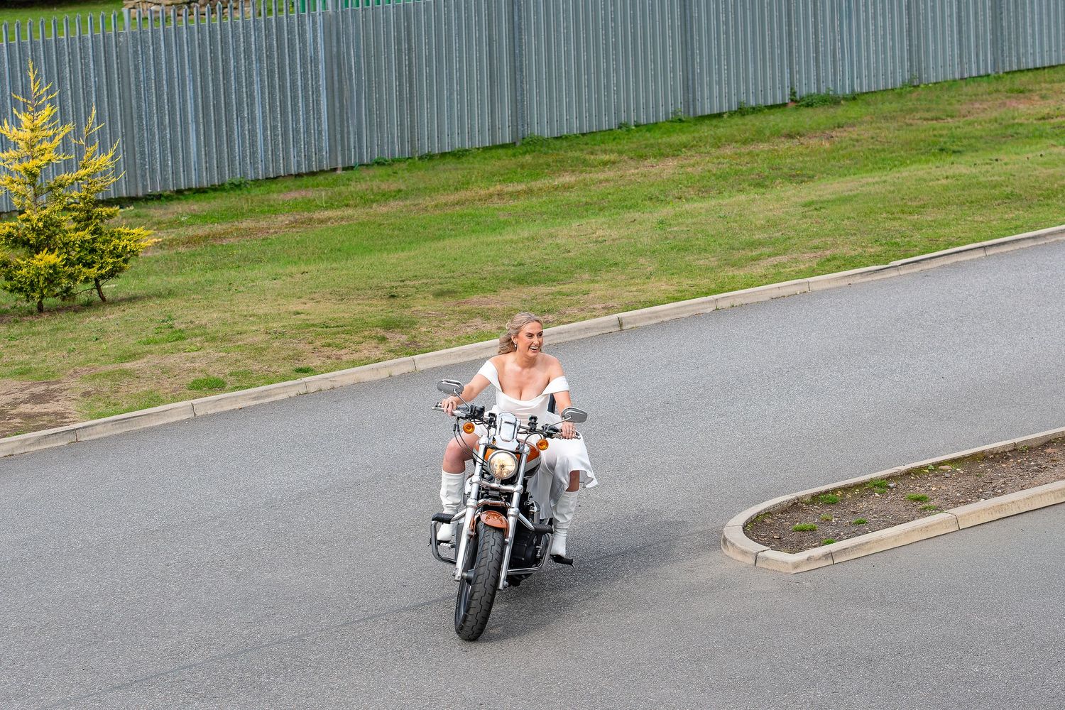 Bride enters the wedding venue on her motorcycle.Yorkshire, Sheffield, Lincolnshire, UK, Leeds, Rotherham