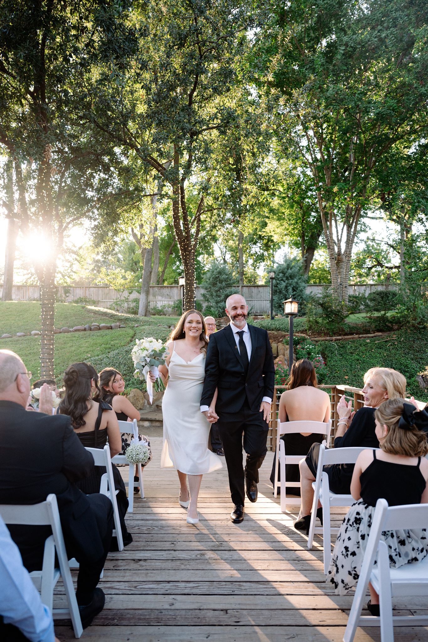 Bride and groom happily walking back up the aisle at a Rainbow Lodge micro wedding.