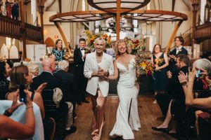 Wedding celebration in historic church hall with vaulted ceilings and wooden beams.