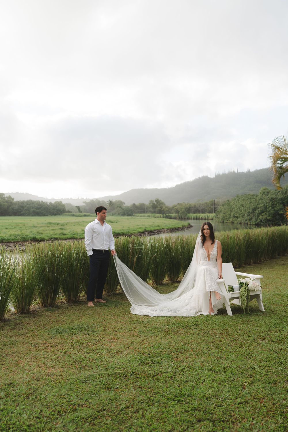 wedding couple posing by Hanalei River