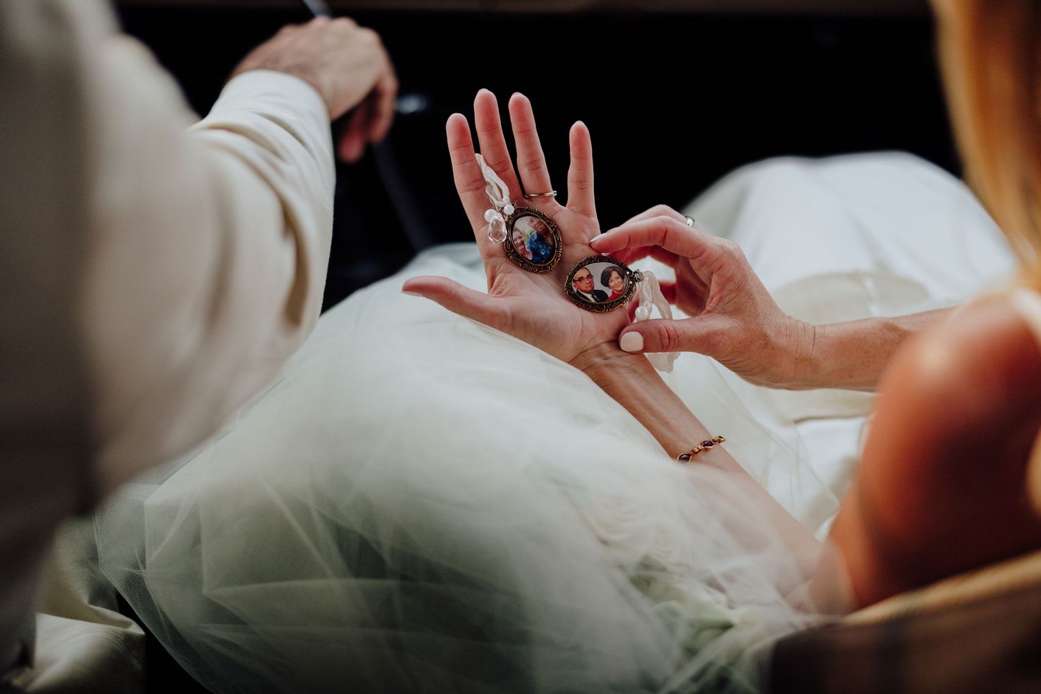 Close-up of bride and groom exchanging ornate wedding rings during ceremony.