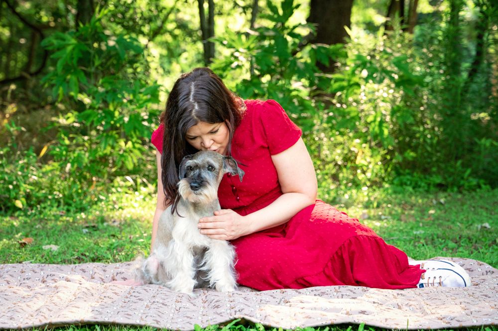 Houston senior dog portrait of owner and elderly dog sharing a quiet, tender moment outdoors.