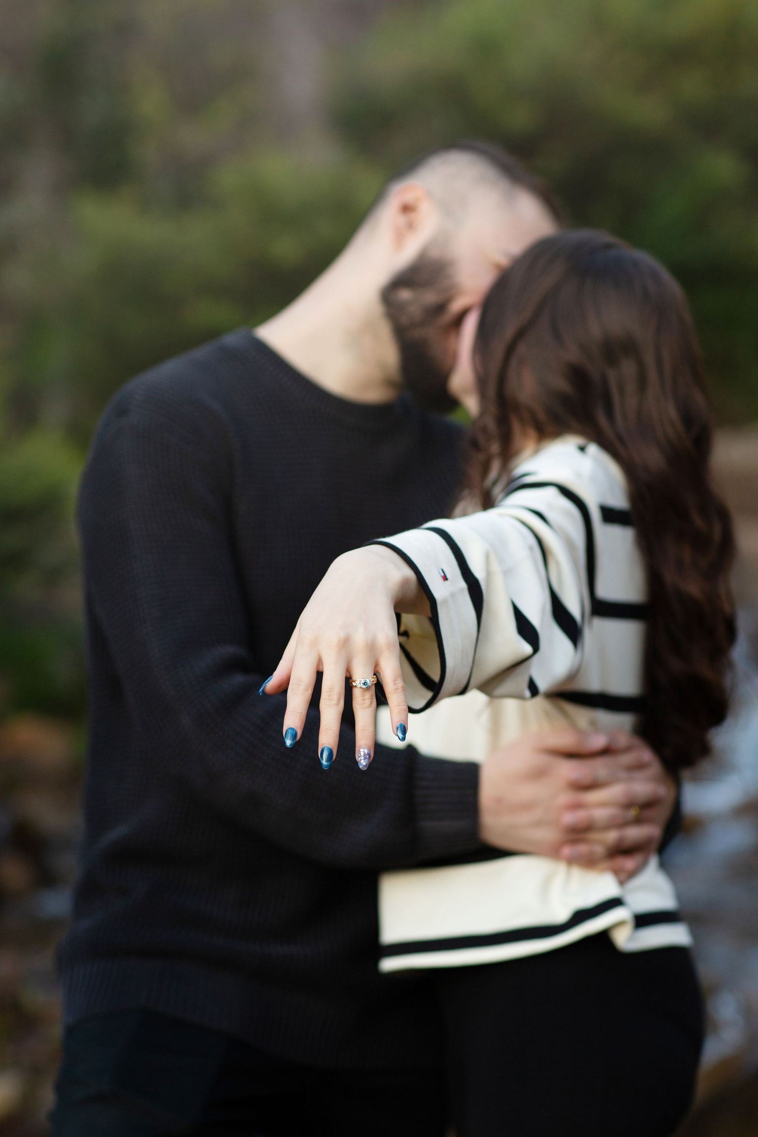 Newly engaged couple showing off engagement ring after their surprise proposal photo session in Perth