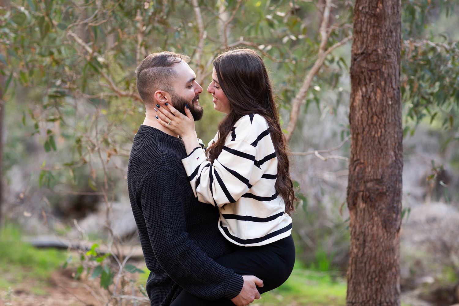 Couple looking into each others eyes after their surprise proposal photo session in Perth