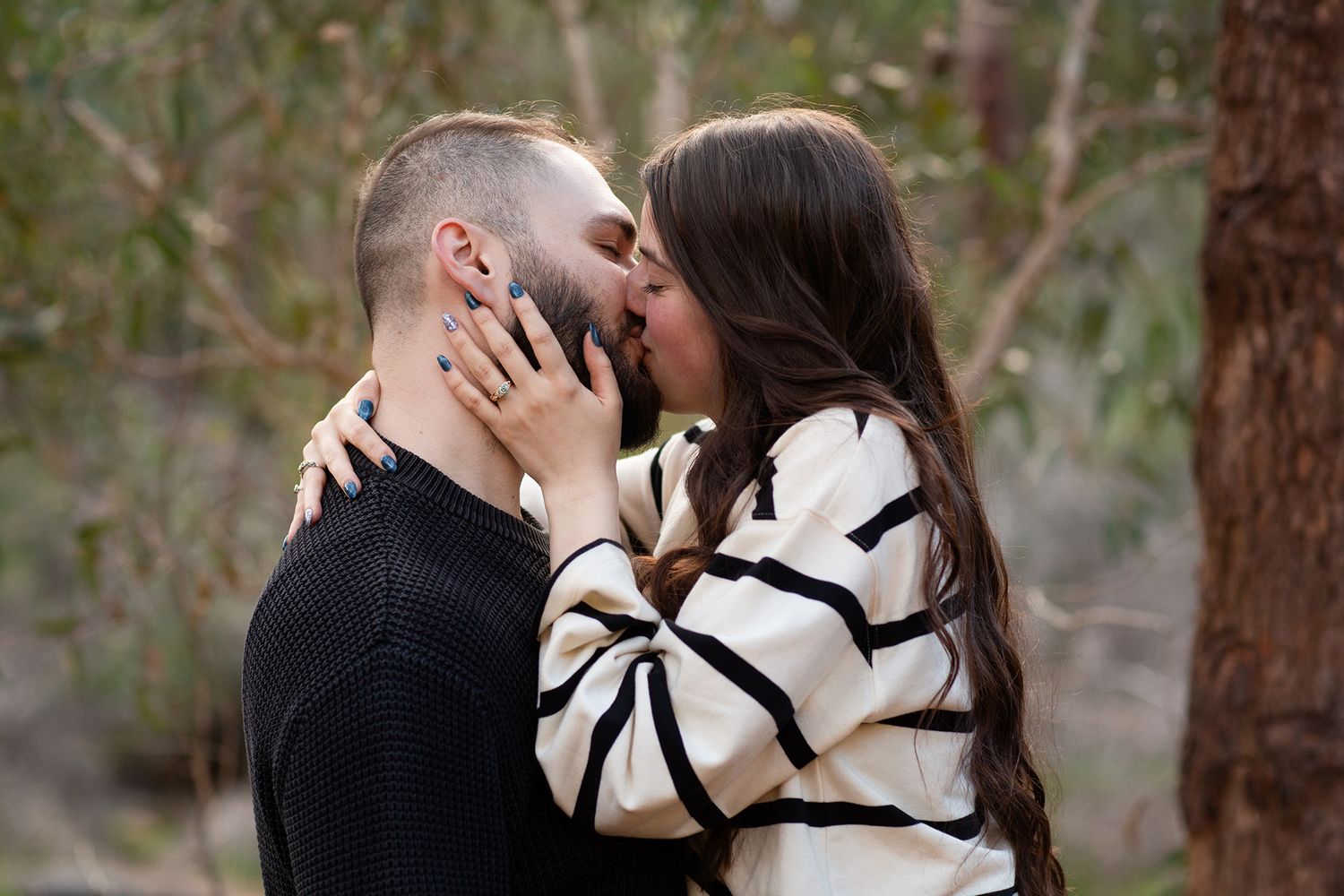 Couple sharing a kiss after their surprise proposal photo session in in Perth