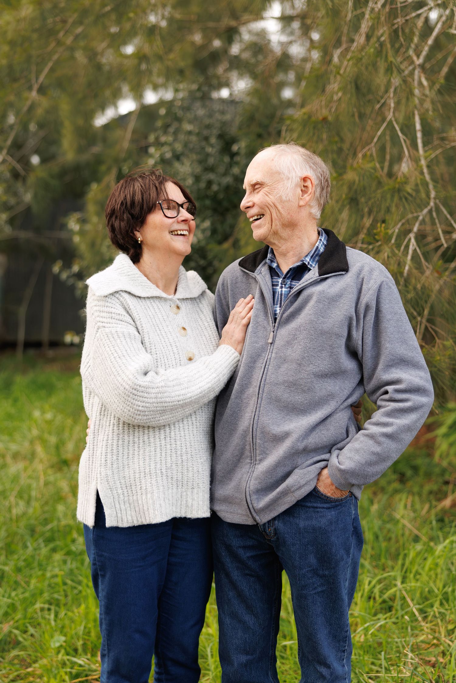 Couple embracing and laughing in a park in Auckland