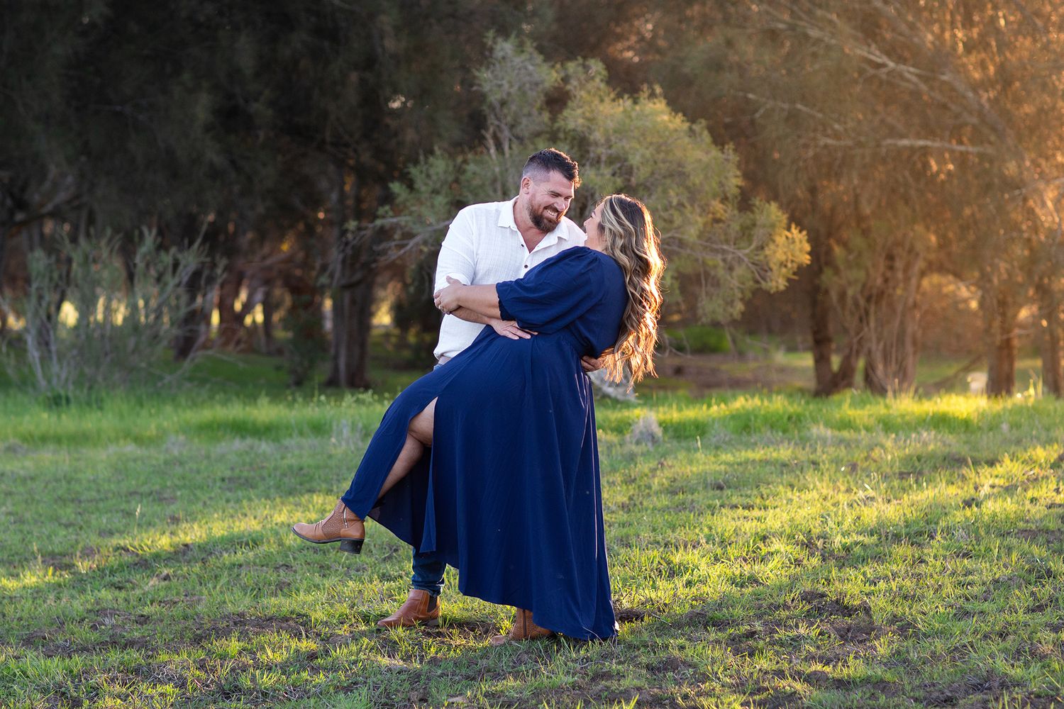 Couple embracing during golden hour in a paddock in Perth