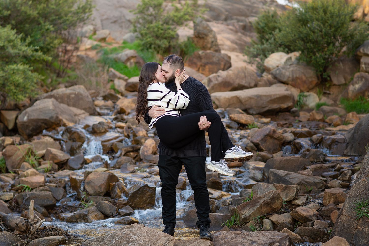 Couple sharing a kiss after their surprise proposal photo session in Perth