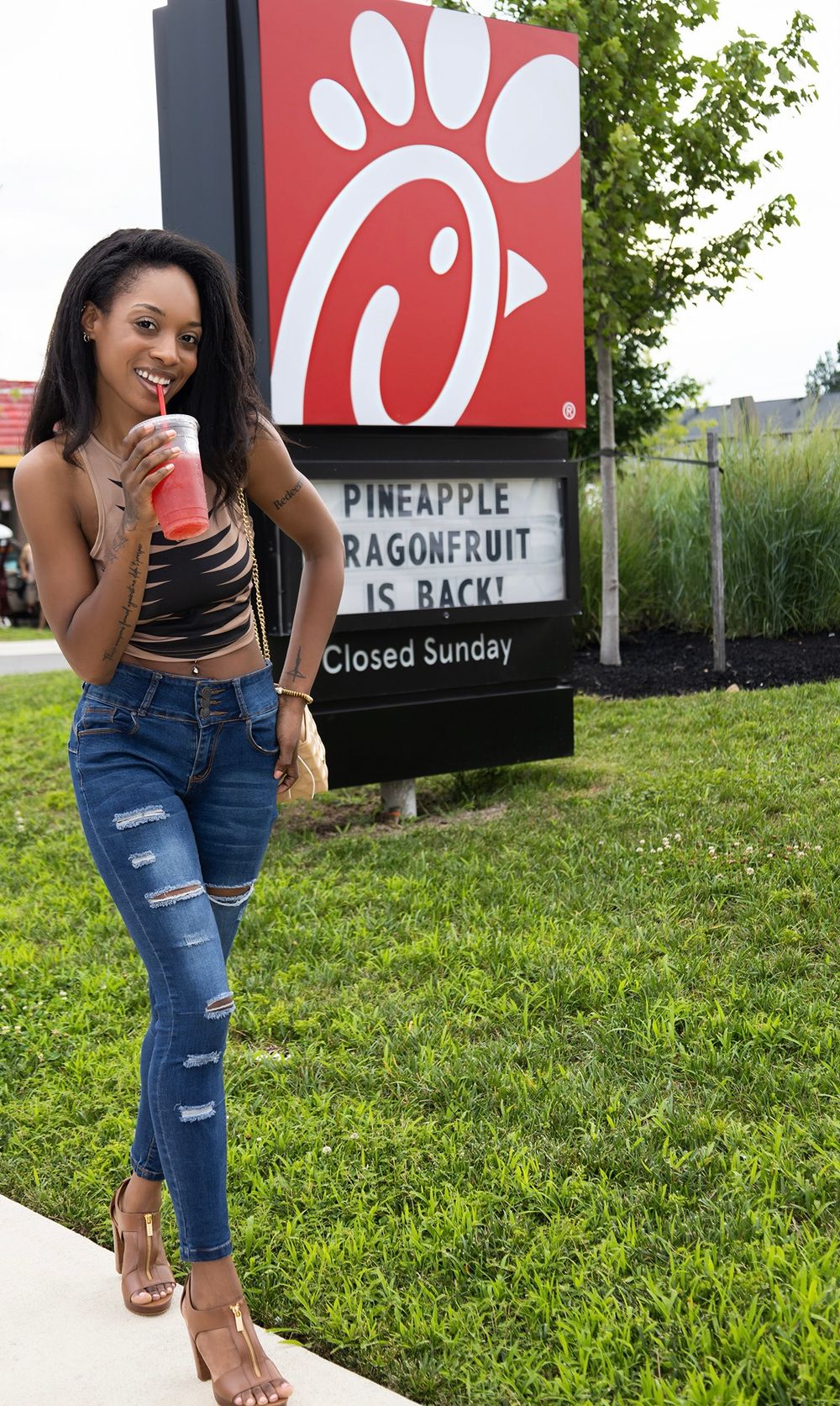 Commercial lifestyle portrait of Genesis Dudley outside a Chick-fi-A restaurant.