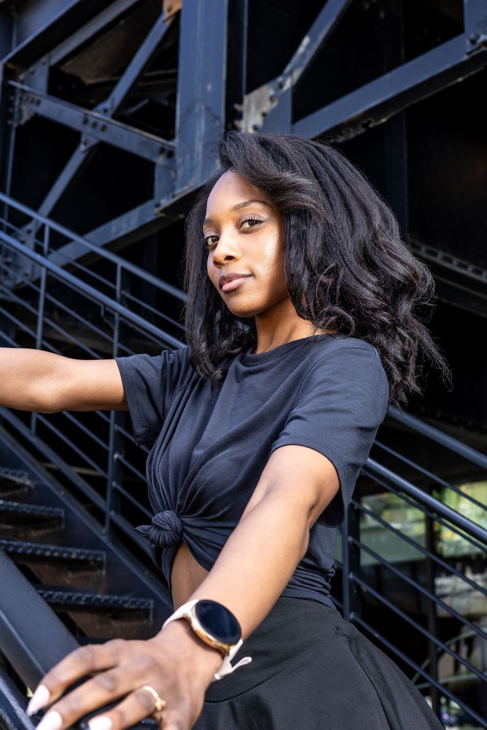 Lifestyle portrait of Genesis Dudley against an urban backdrop.