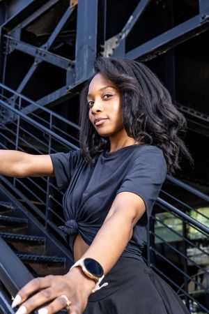 Lifestyle portrait of Genesis Dudley against an urban backdrop.