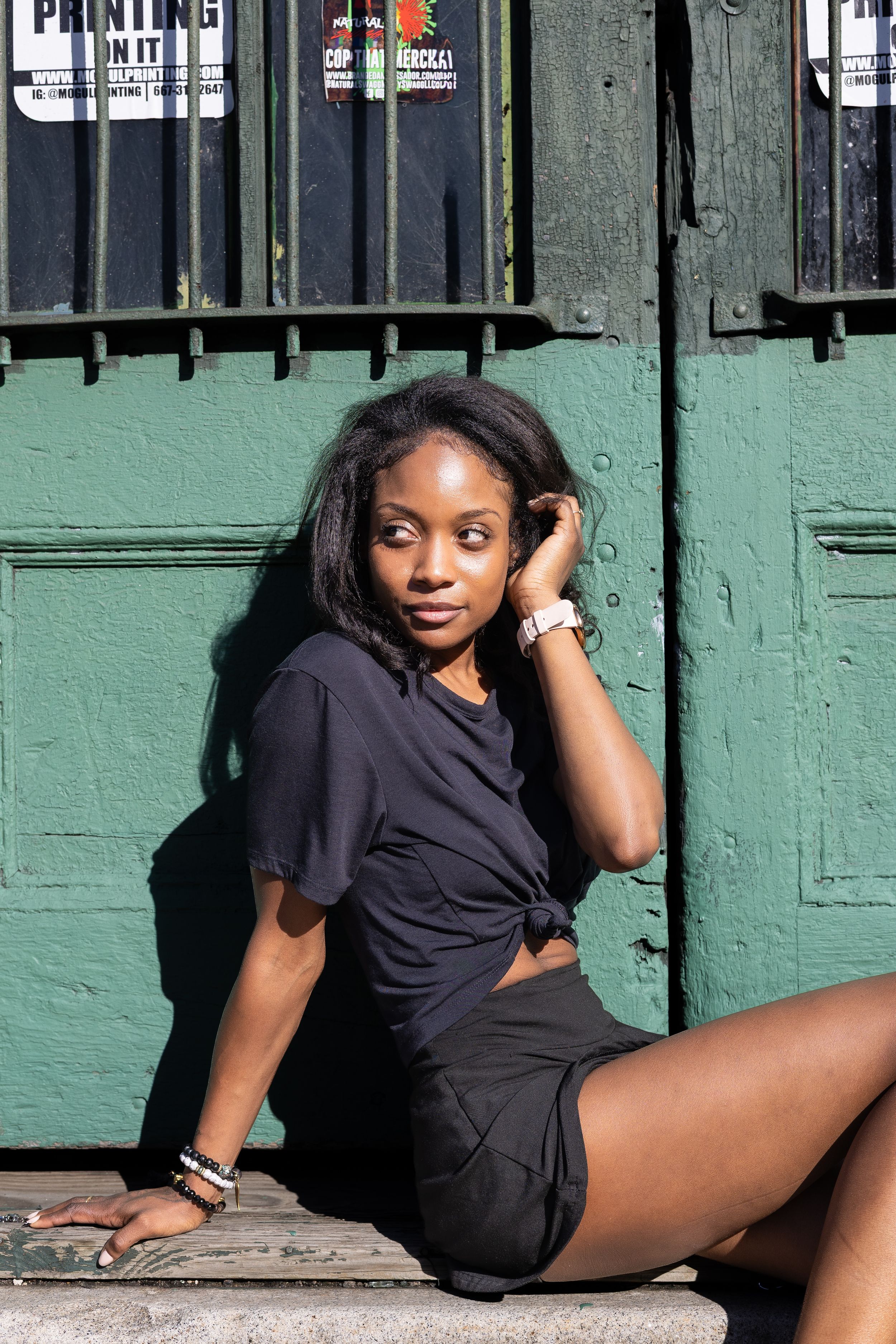 Portrait of Genesis Dudley seated against an urban backdrop.