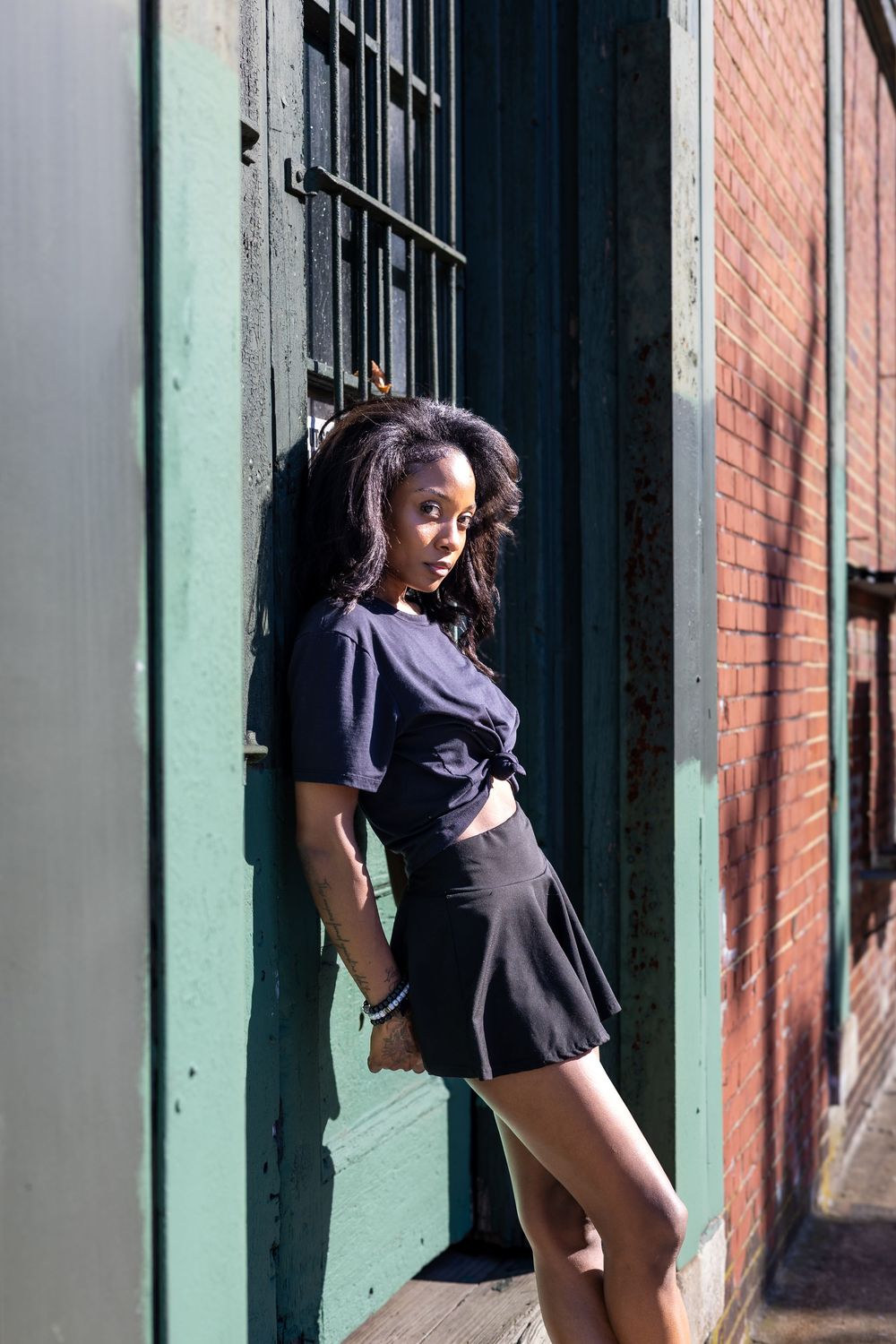 Portrait of Genesis Dudley against an urban backdrop.