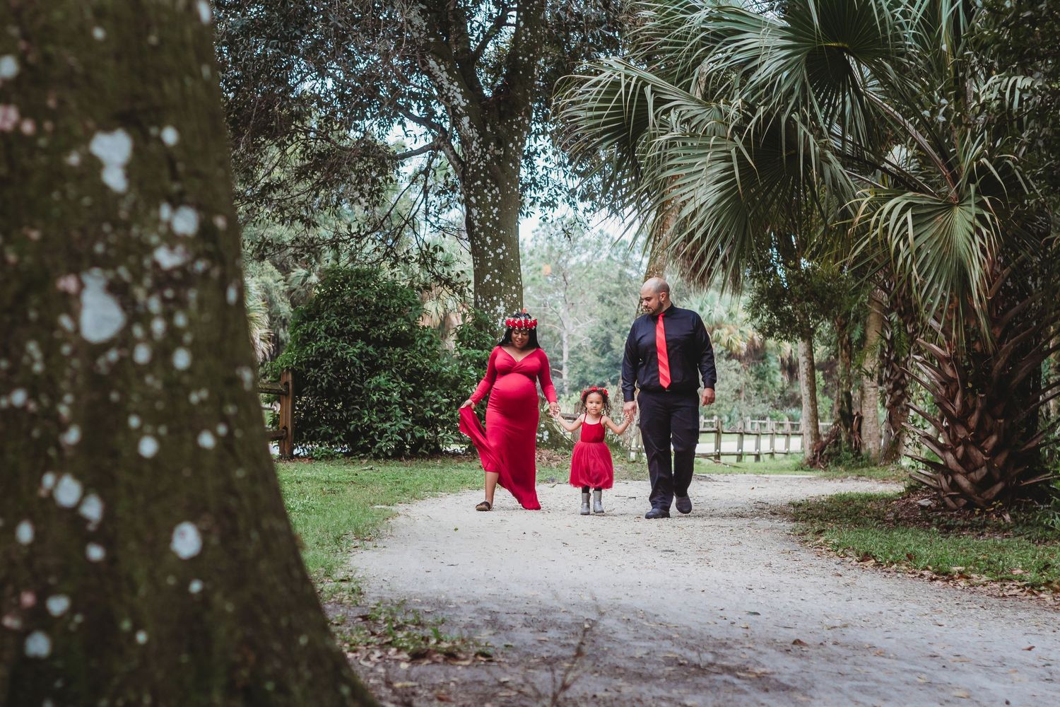 Family maternity portrait session at Riverbend Park in Jupiter, Florida featuring the park's beautiful banyan trees and natural trails.