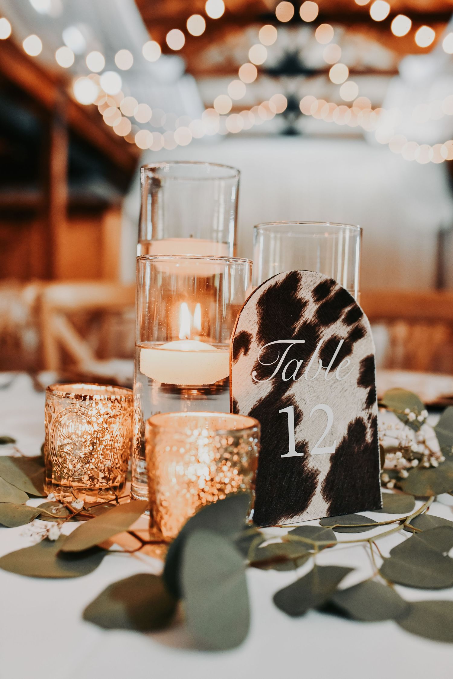 Romantic Lucky Spur Ranch wedding reception details with greenery and gold decor