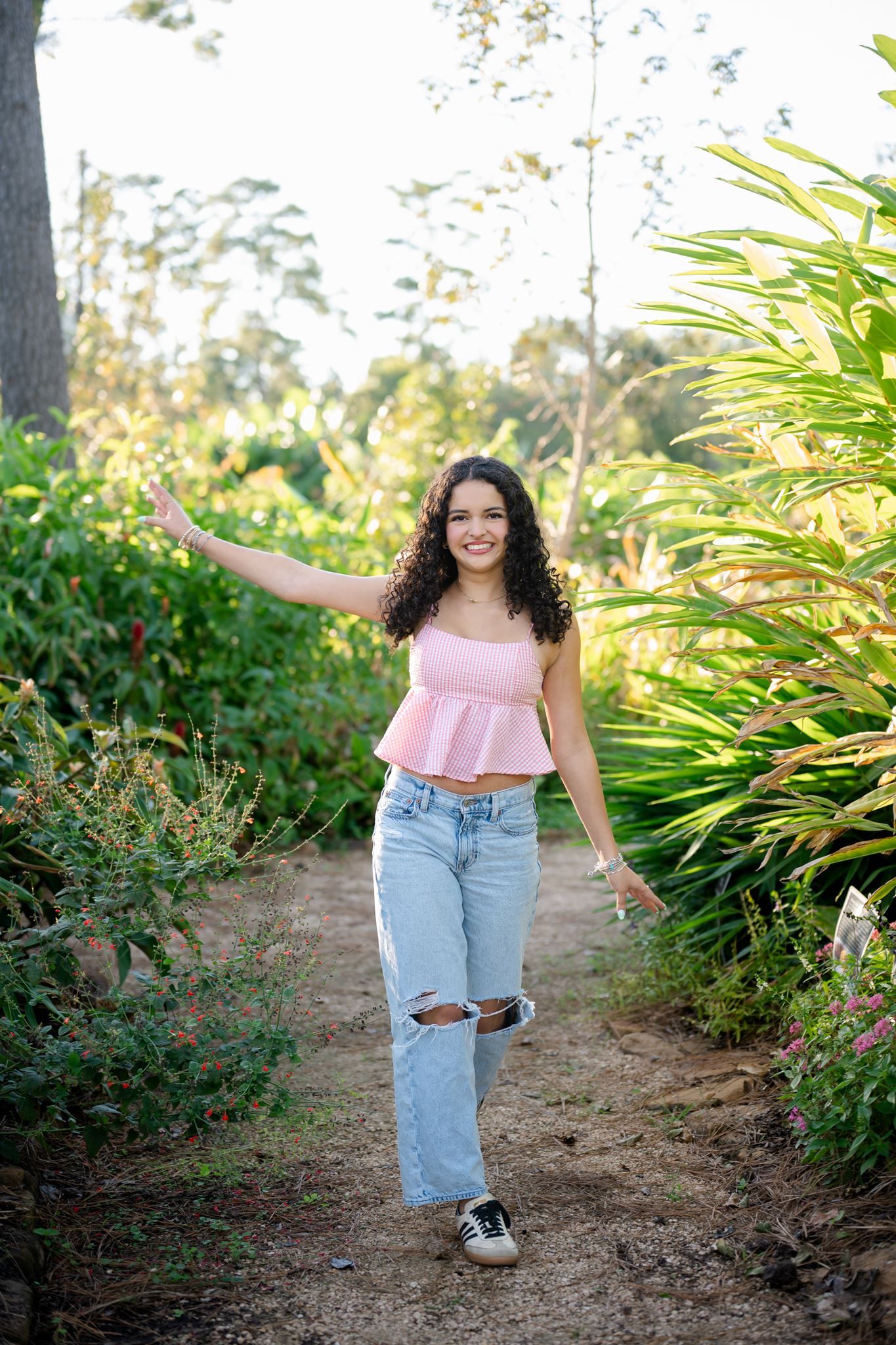 College Park High School senior playfully walking through the gardens.