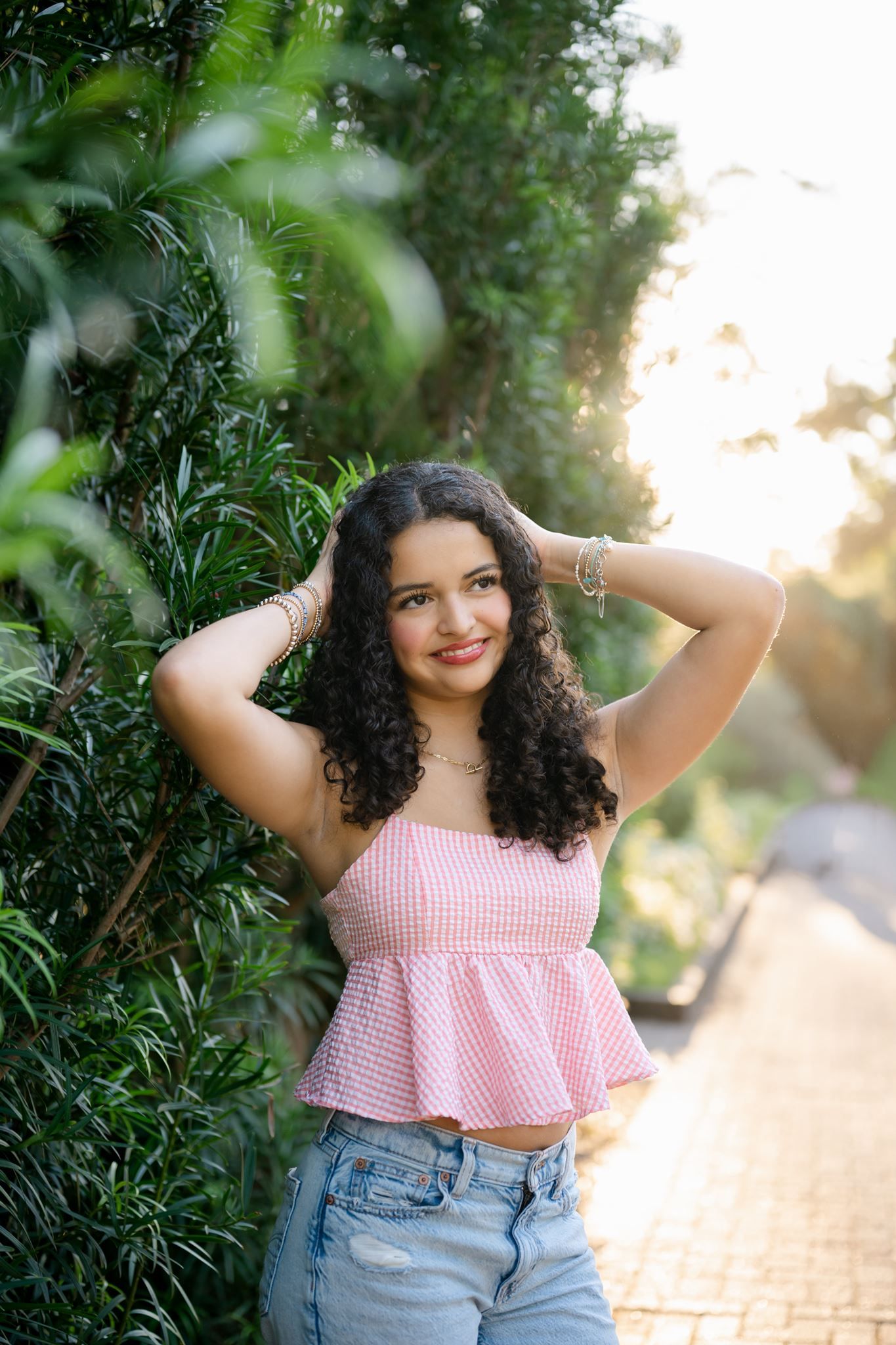 College Park High School senior Cristina wearing a pink and white top at Mercer Botanic Gardens.