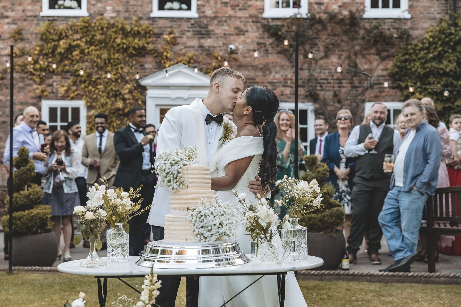 Newly weds cake cutting outside Bardney Hall.