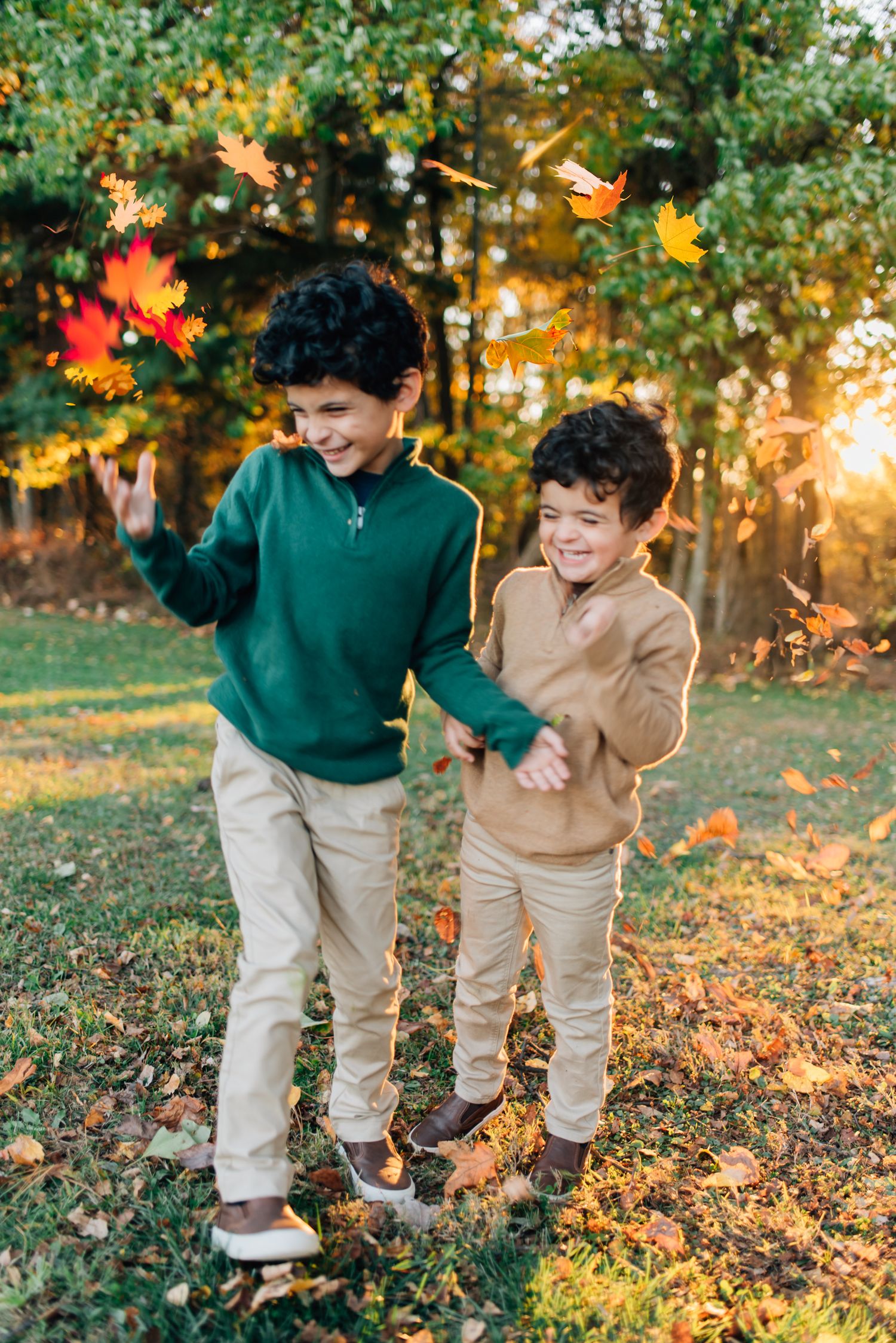 Kids throwing leaves in fall foliage in Pittsburgh, PA