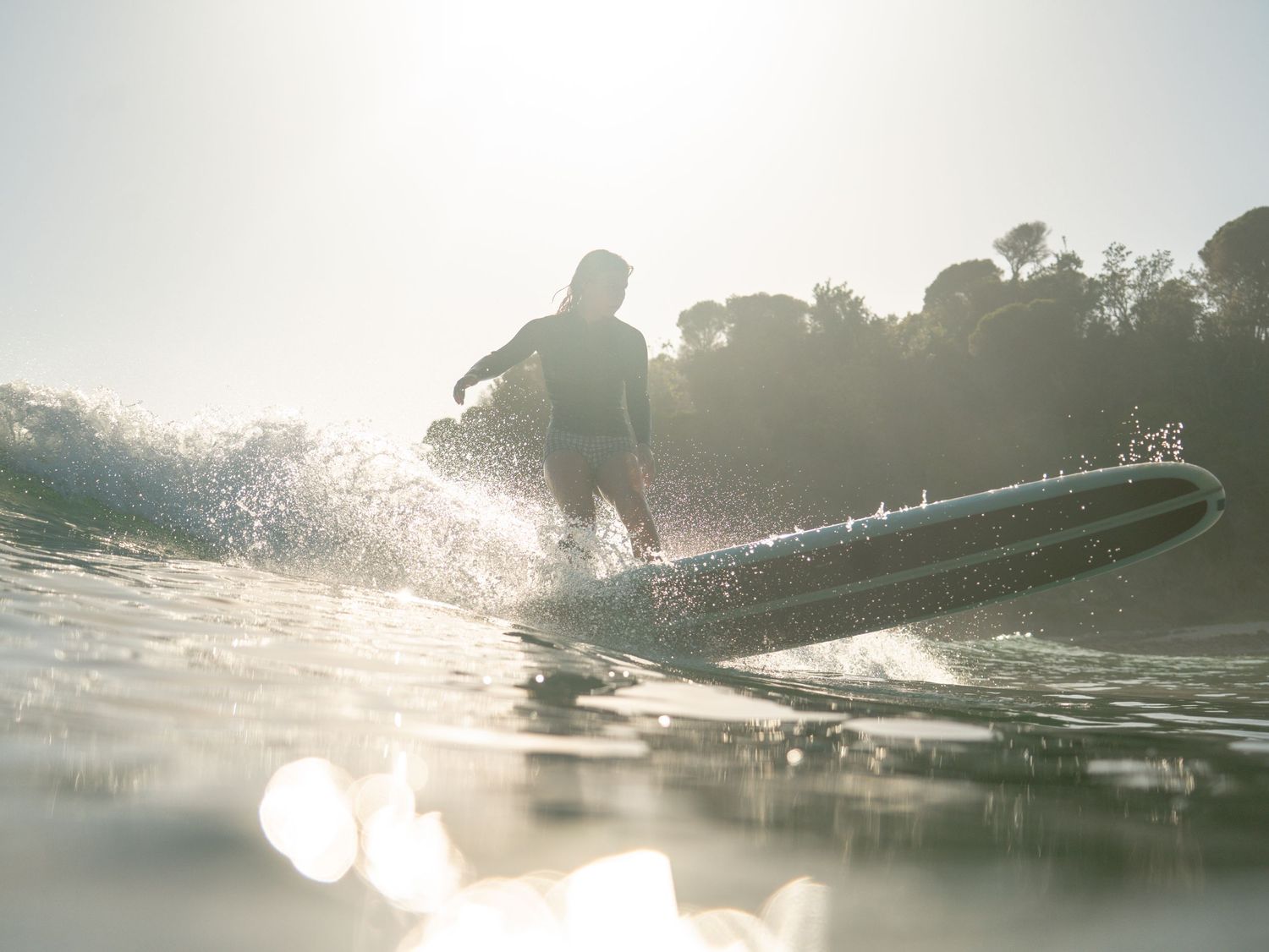 Female Longboarder surfing a beautiful point break near Newcastle, NSW on the Mid North Coast captured by a local female surf photographer