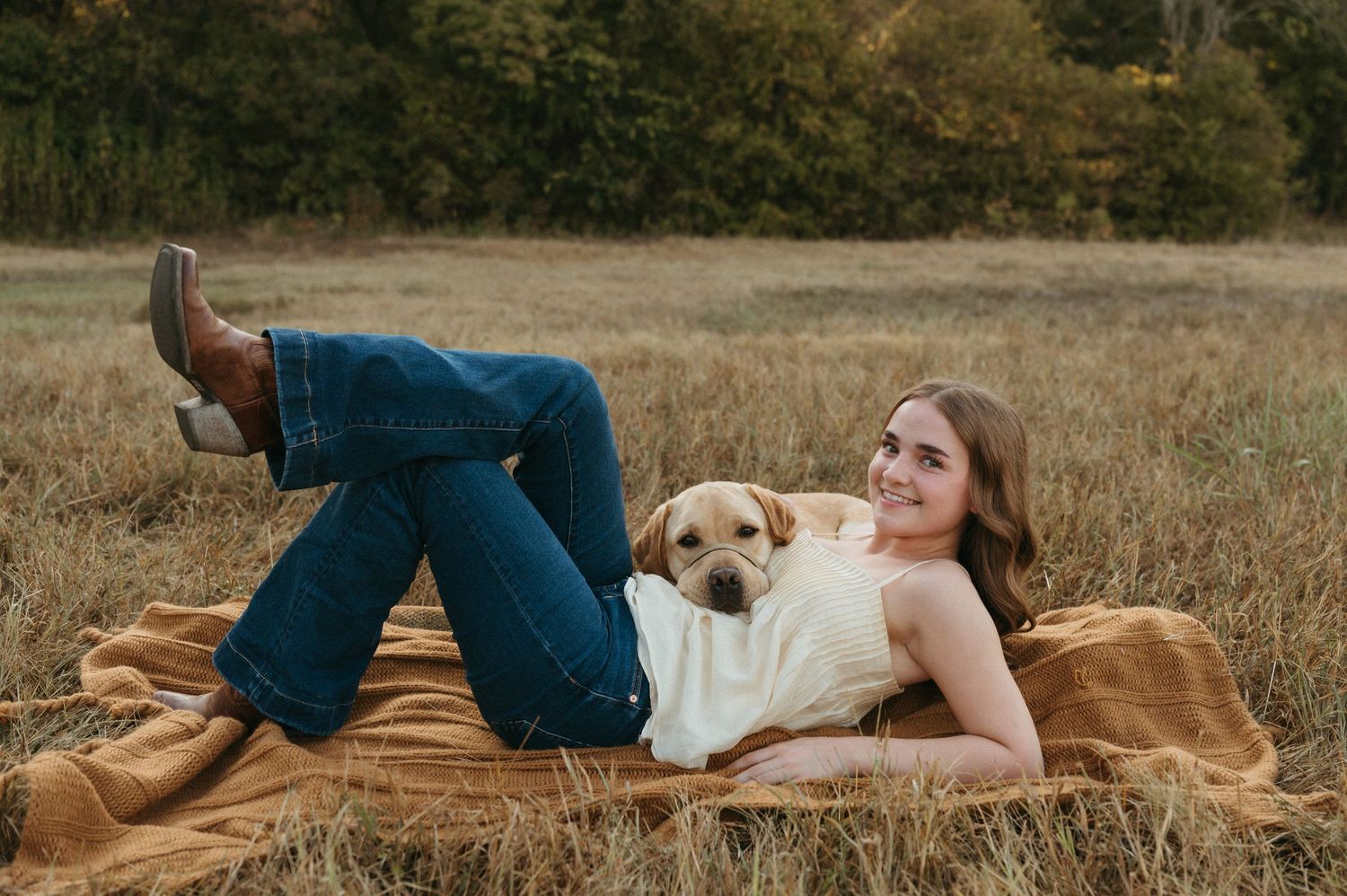 Natural senior photo of Lauren and Opus interacting in a grassy field in Plano, Texas