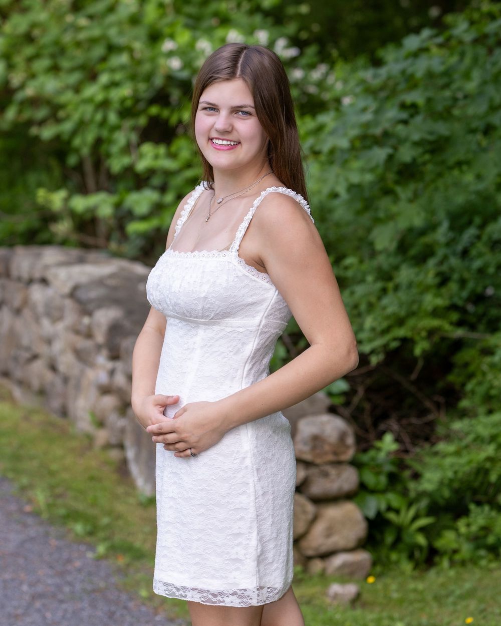 Lincoln Sudbury graduate poses in graduation dress for individual senior portrait during cap & gown. Weston High, Wayland, Nashoba Regional