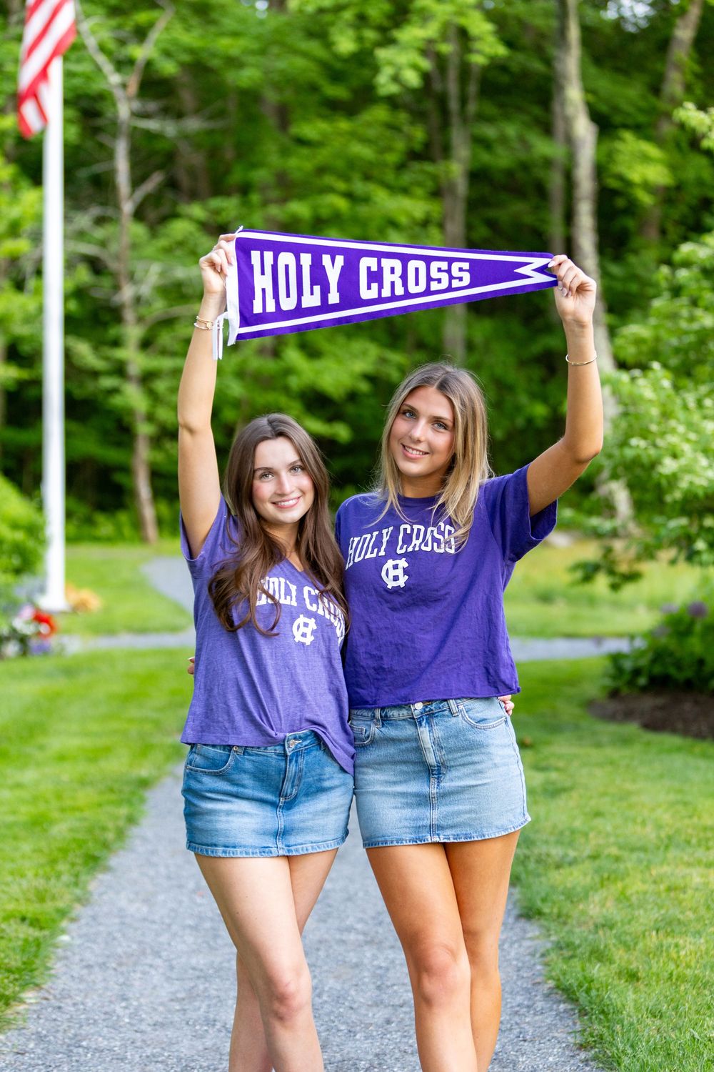 HS graduates pose during their cap & gown session in their future college tshirts & pennants.  Weston high school, Wayland, Lincoln Sudbury