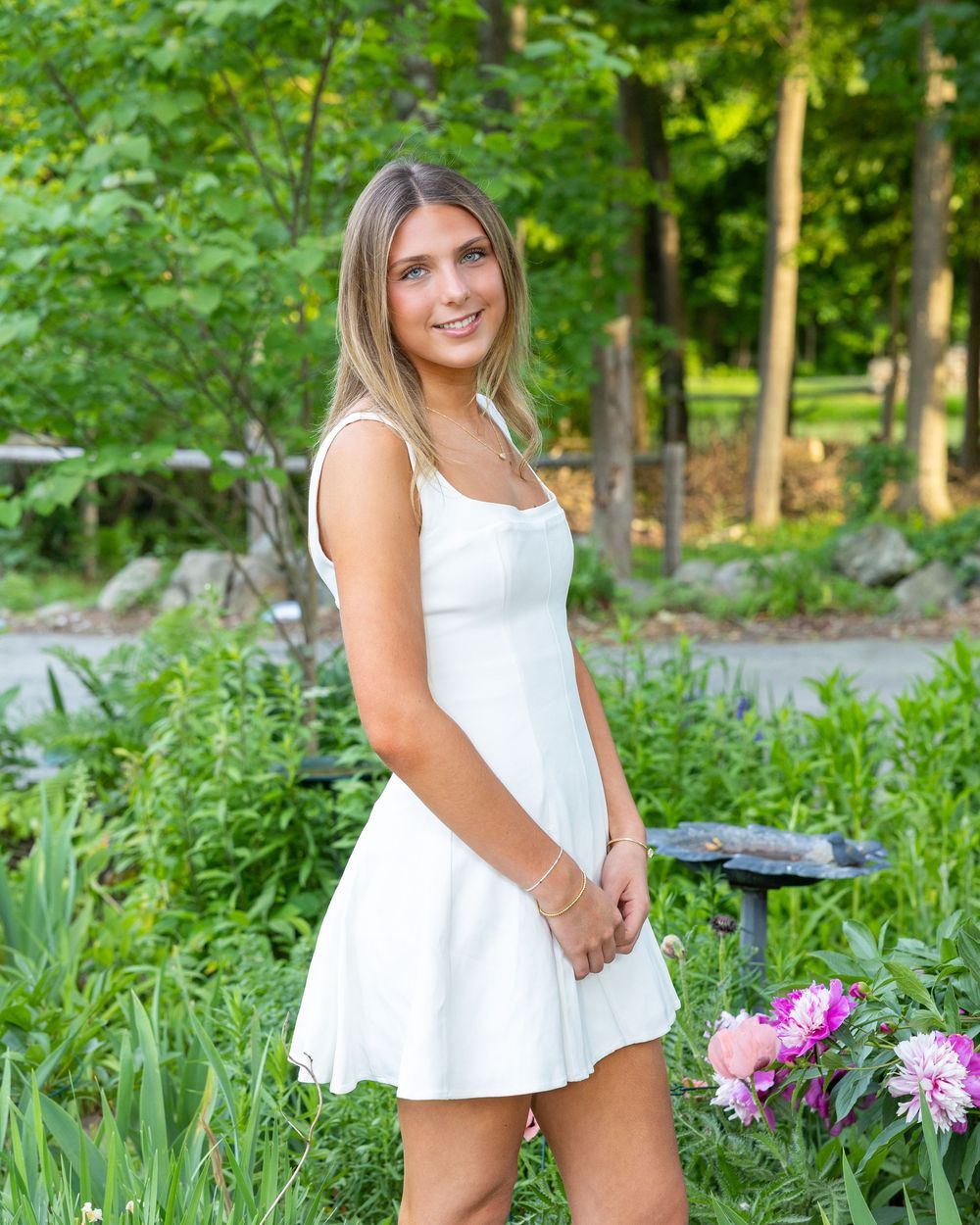 Lincoln Sudbury graduate poses in graduation dress for individual senior portrait during cap & gown. Weston High, Wayland, Concord Carlisle.