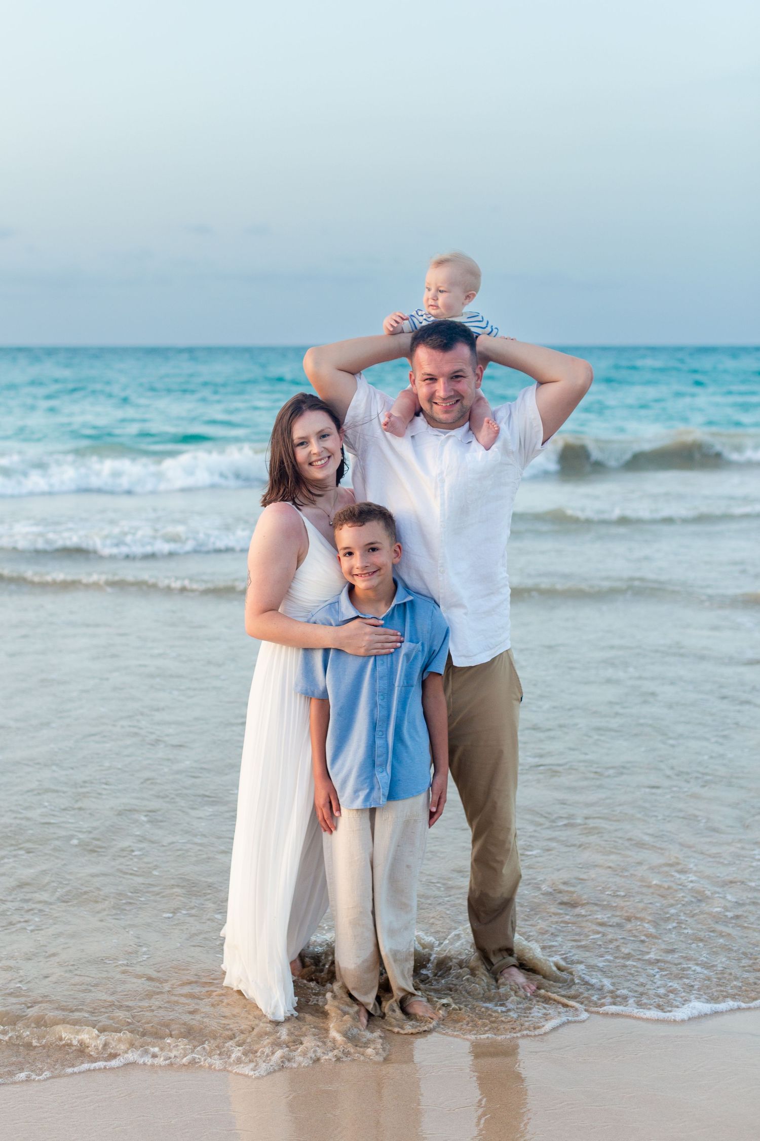 Family portrait on the beach in Isla Verde, Carolina, Puerto Rico. Father, mother and two sons.