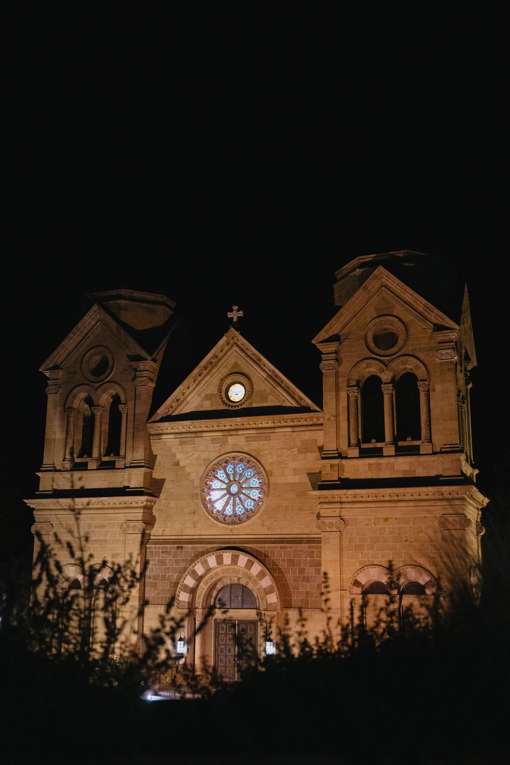 Cathedral Basilica of St. Francis of Assisi illuminated at night in Santa Fe, New Mexico.