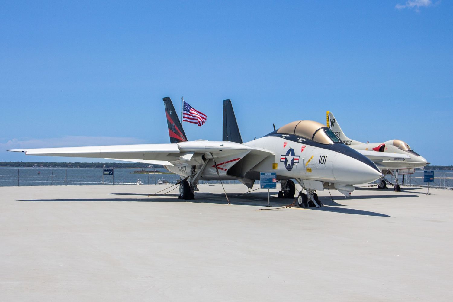 U.S. Navy F-14 Tomcat fighter jet on display at an outdoor military aviation museum under clear blue sky.