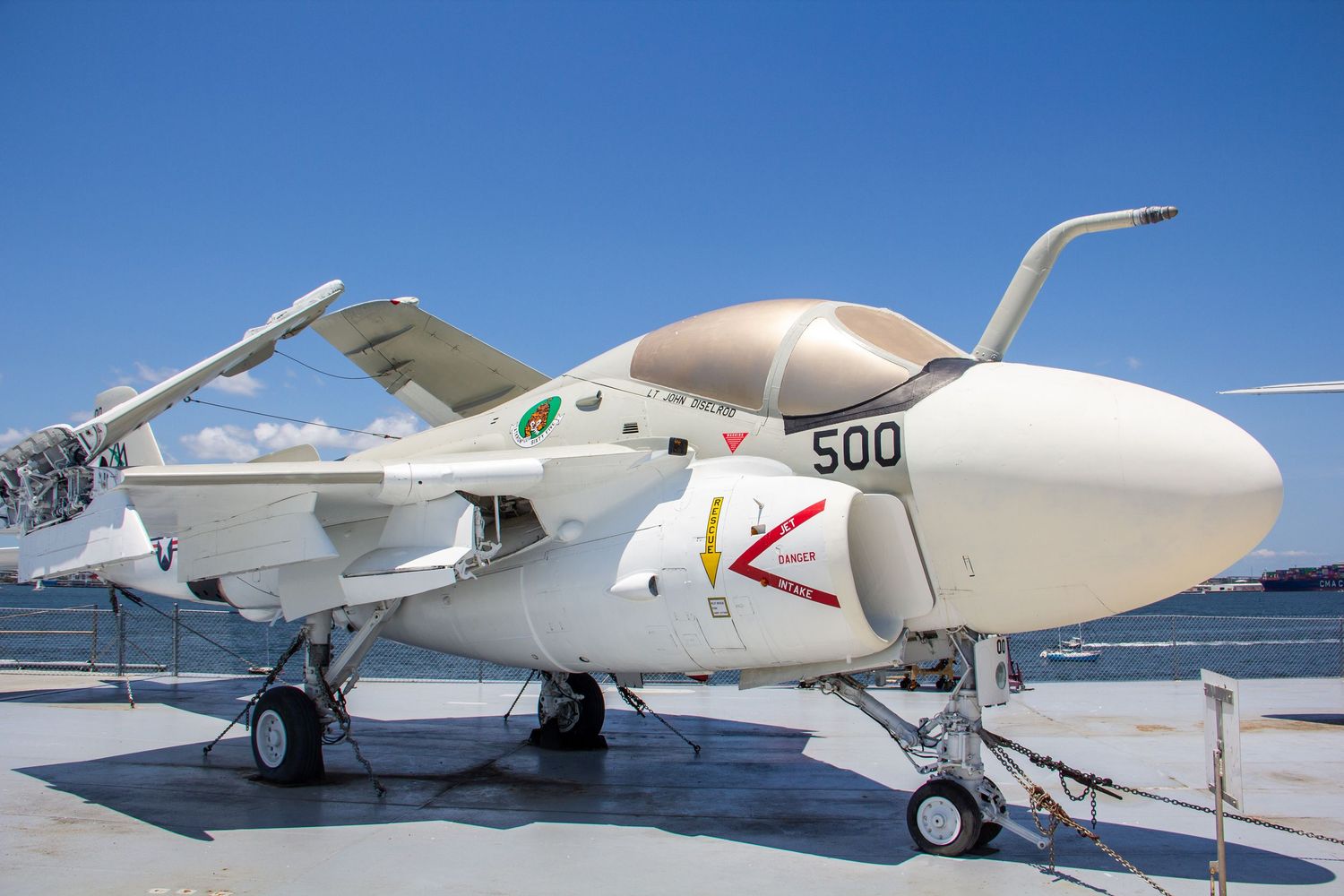 White military jet aircraft numbered 500 on display outdoors, likely at a naval aviation museum on a sunny day.