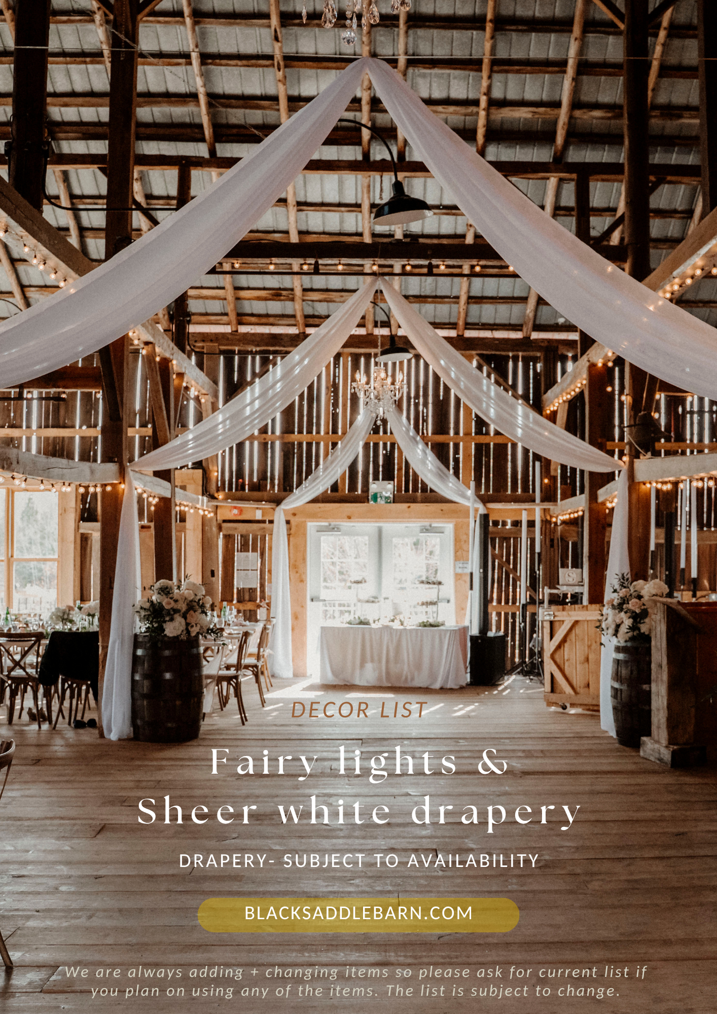 Rustic barn wedding venue decorated with fairy lights and sheer white drapery, featuring elegant table settings and warm ambient lighting.