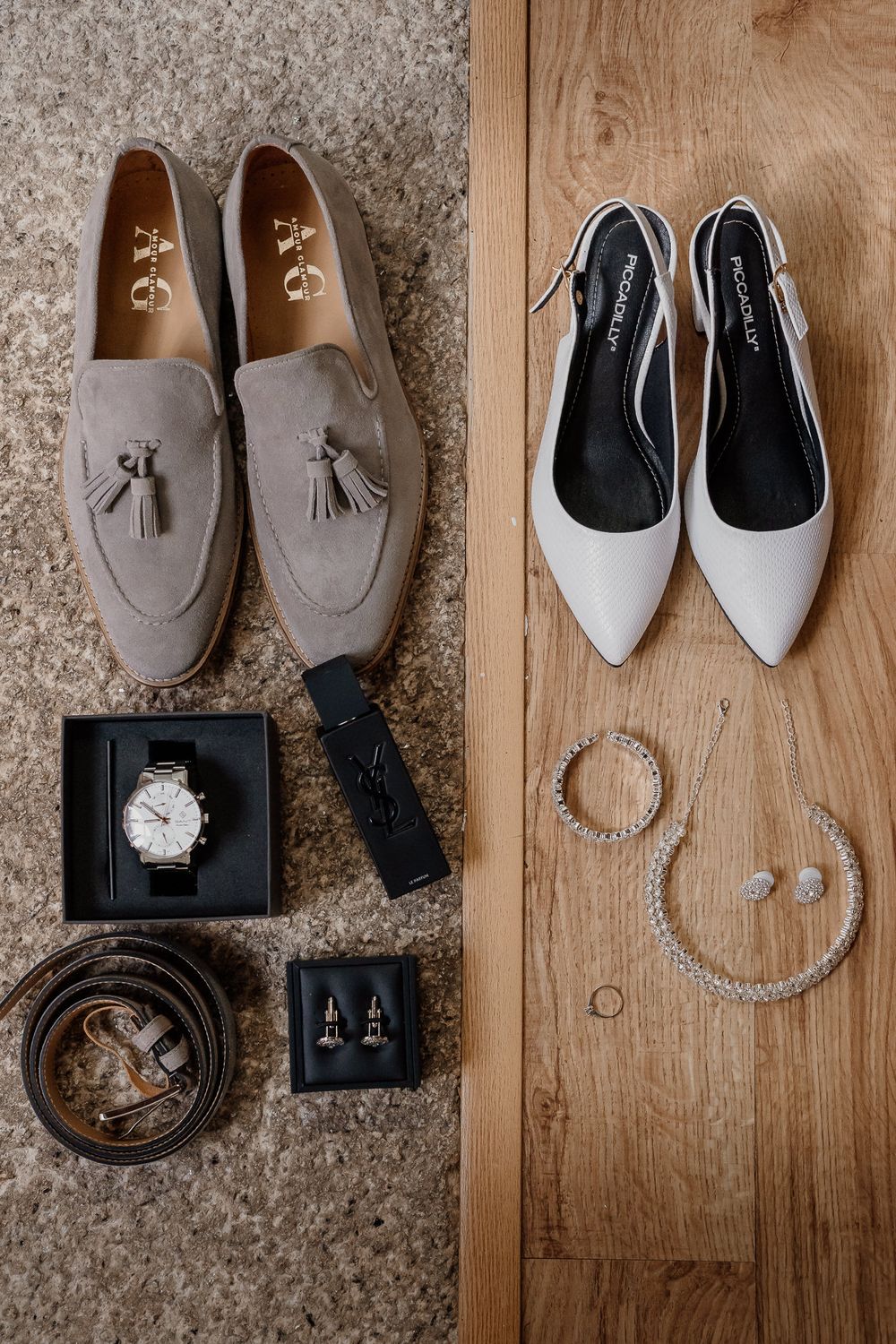 Wedding flat lay featuring groom suede loafers, watch, belt, cufflinks beside bride white heels, pearl necklace, and earrings.