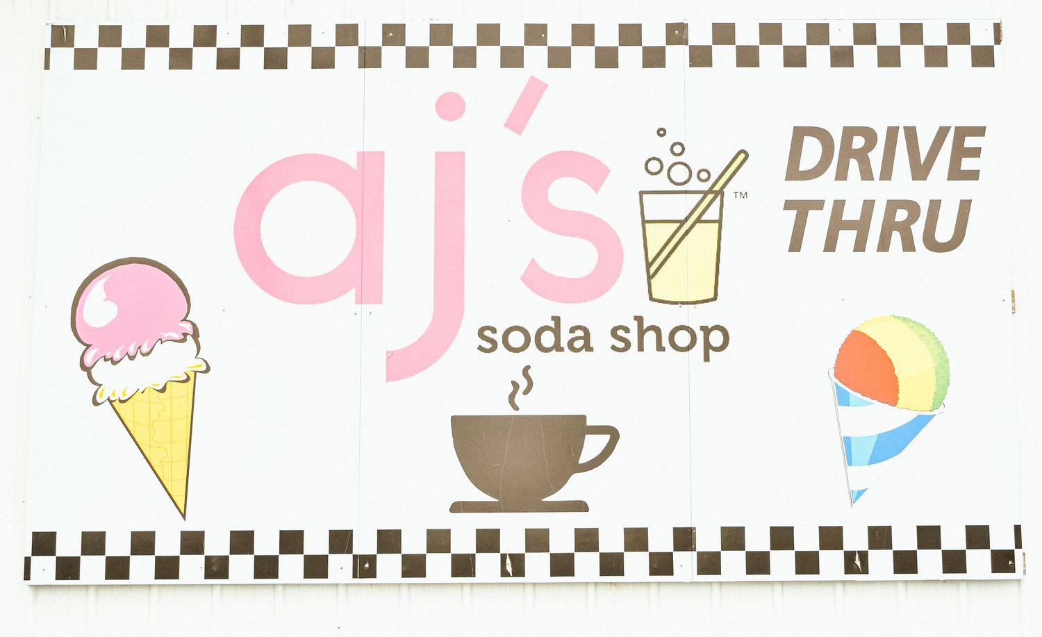 AJ's Soda Shop drive-thru sign featuring ice cream cone, coffee cup, soda drink, and snow cone illustrations.
