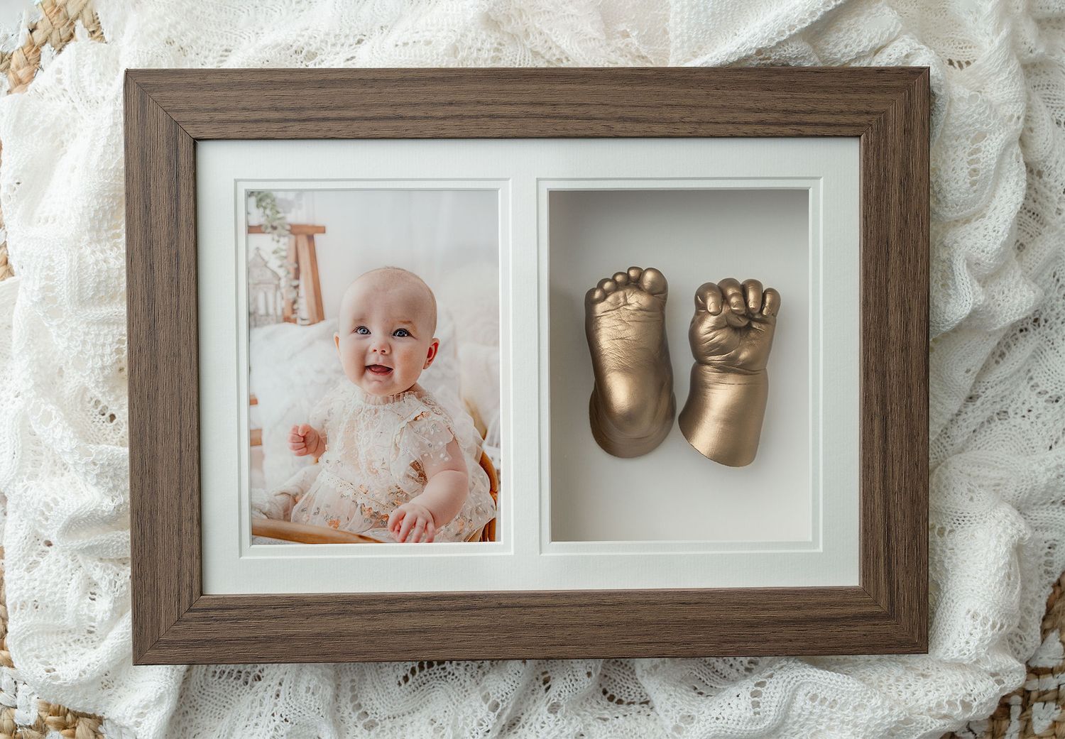 Rustic wood shadow box frame displaying a baby photo and gold bronze cast of infant feet and hands keepsake created at Ada Studio Oban
