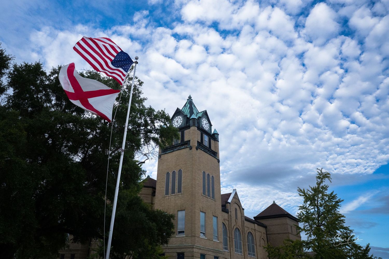 American and Alabama flags waving before the historic Prattville clock tower in Alabama, fine art photo by Steve Cole.