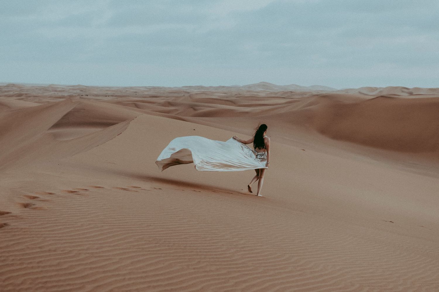 Destination luxury photoshoot for visitors to Namibia. Flying dress photoshoot